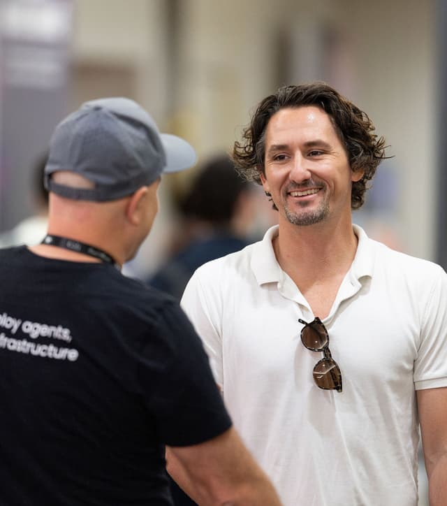 Two men speaking to each other.