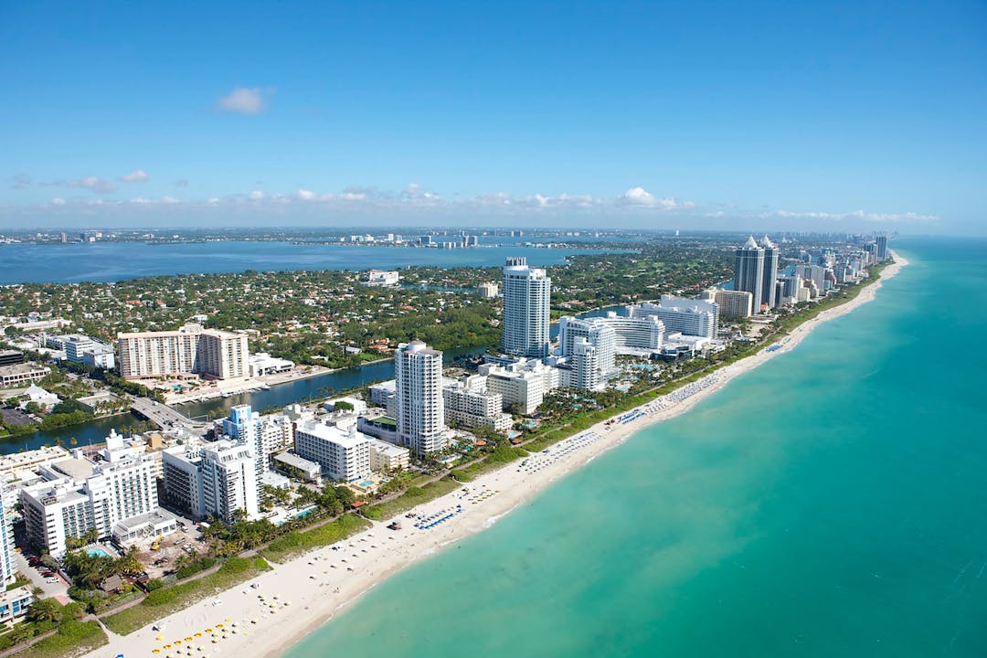 An aerial view of a beach and a city