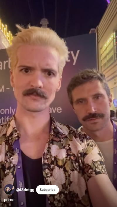 A man with a moustache standing next to another man with a moustache