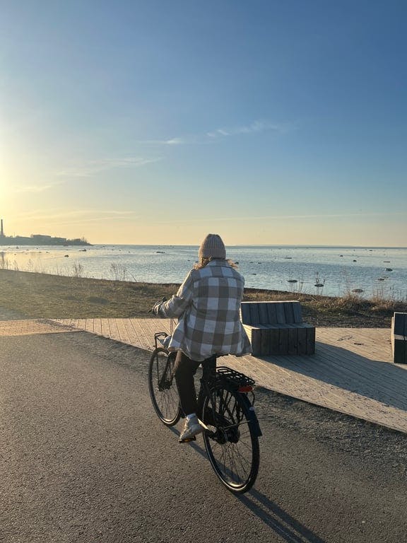 A person riding a bike near a beach
